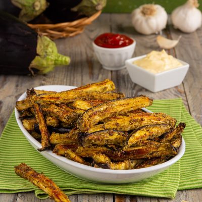 Stick di melanzane al forno con panatura dorata e aromatica, serviti con salsa rossa e maionese all'aglio